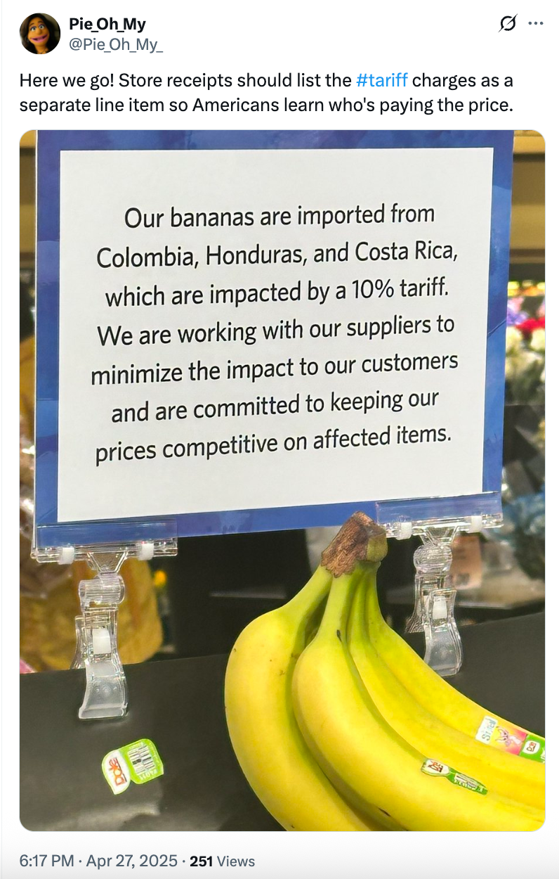 Sign explains that bananas are imported from Colombia, Honduras, and Costa Rica with a 10% tariff, and store aims to minimize customer impact