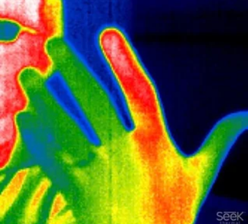 A thermal image showing a person holding their hand to their face, with one finger registering as much hotter