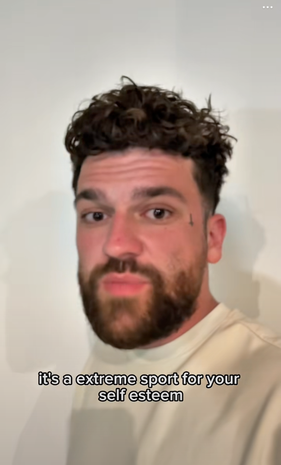 A person with a beard and curly hair looks at the camera. Text reads, "it's an extreme sport for your self esteem."