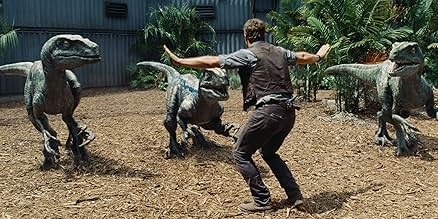 A person cautiously gestures at three velociraptors, appearing to train or calm them in a jungle setting