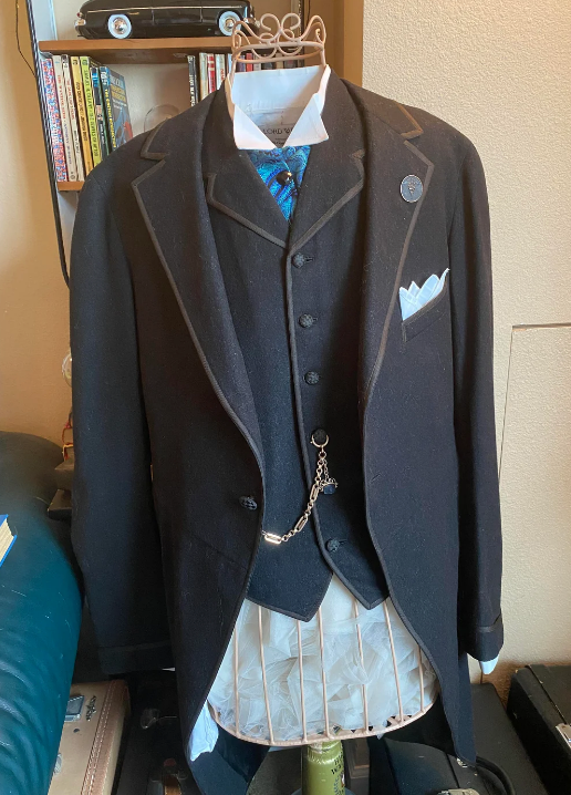 Vintage three-piece suit on a mannequin, featuring a pocket watch and chain