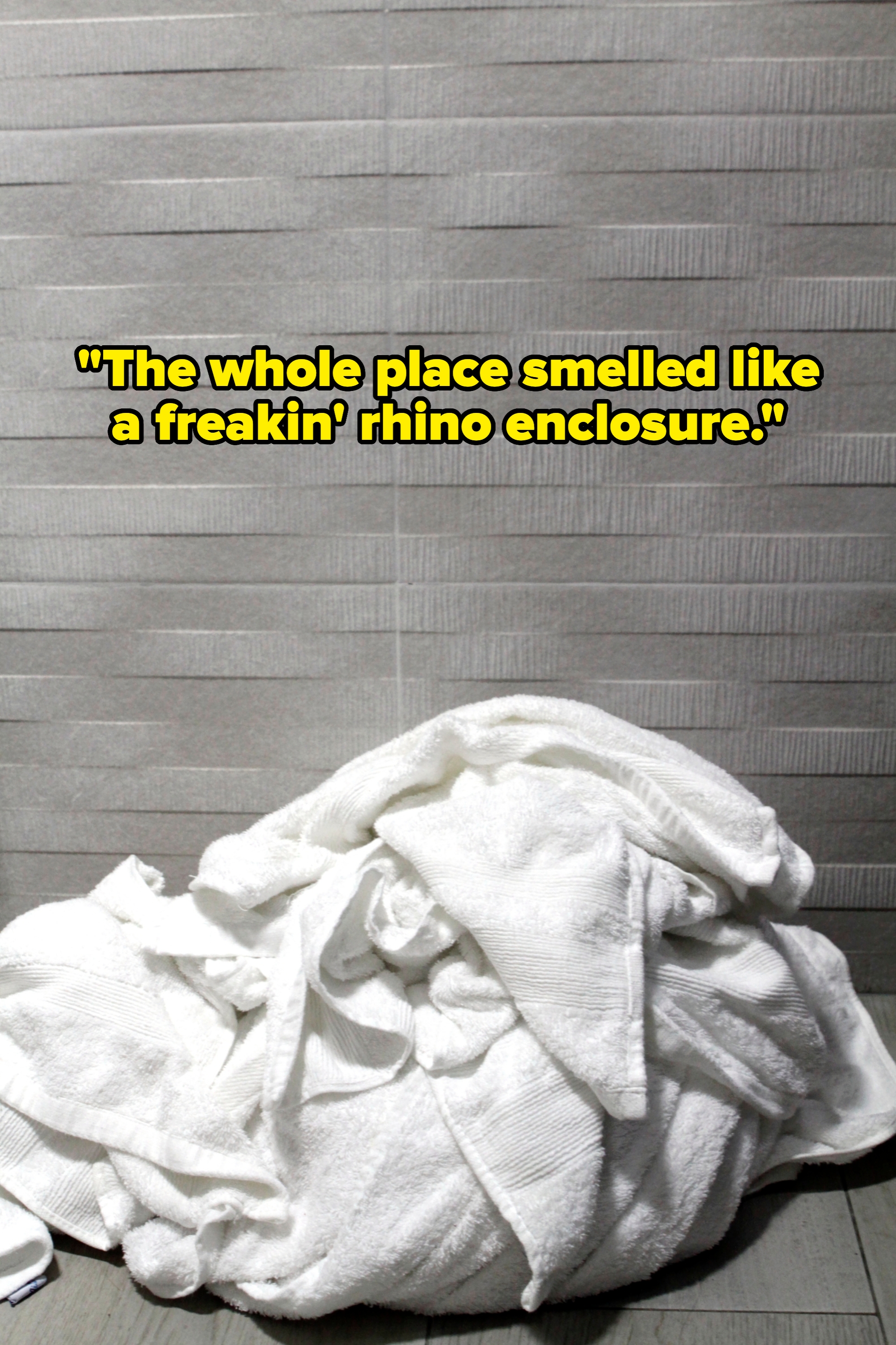 Pile of white towels on a tiled floor