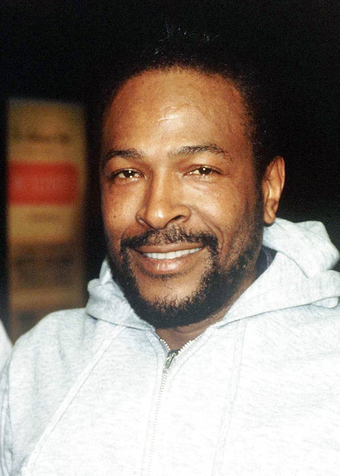 A man smiling warmly, wearing a casual hoodie