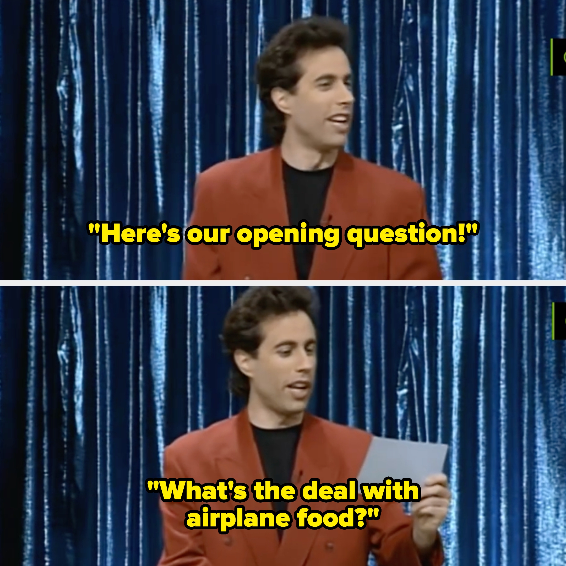 Person in red jacket holding a card on stage with a shimmering curtain backdrop. They appear to be speaking or performing