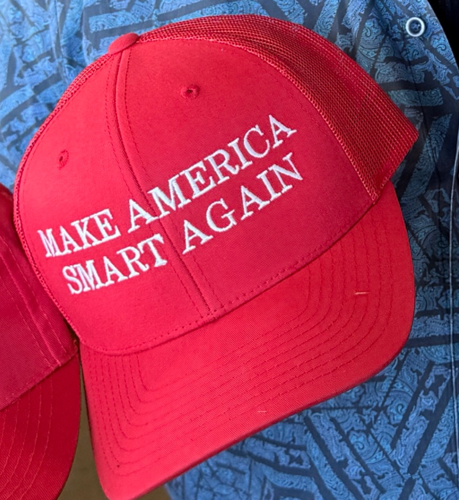 Red baseball cap with "Make America Smart Again" embroidered in white