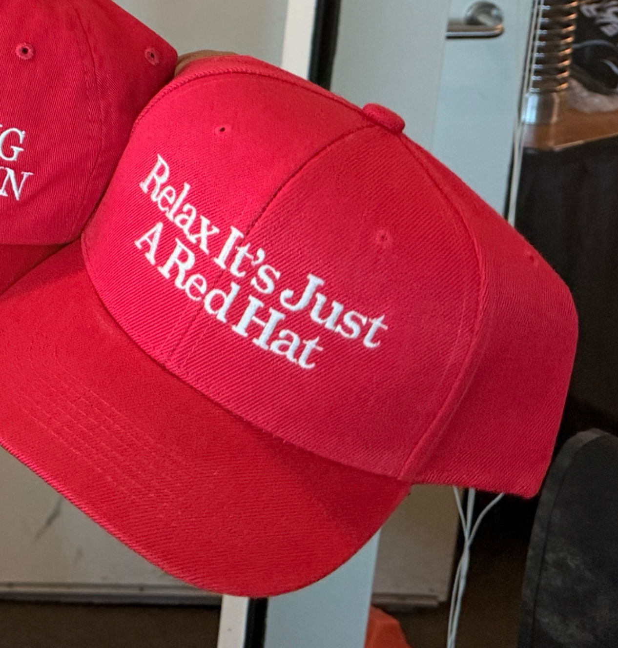 Red hats with text: "Relax It's Just A Red Hat."