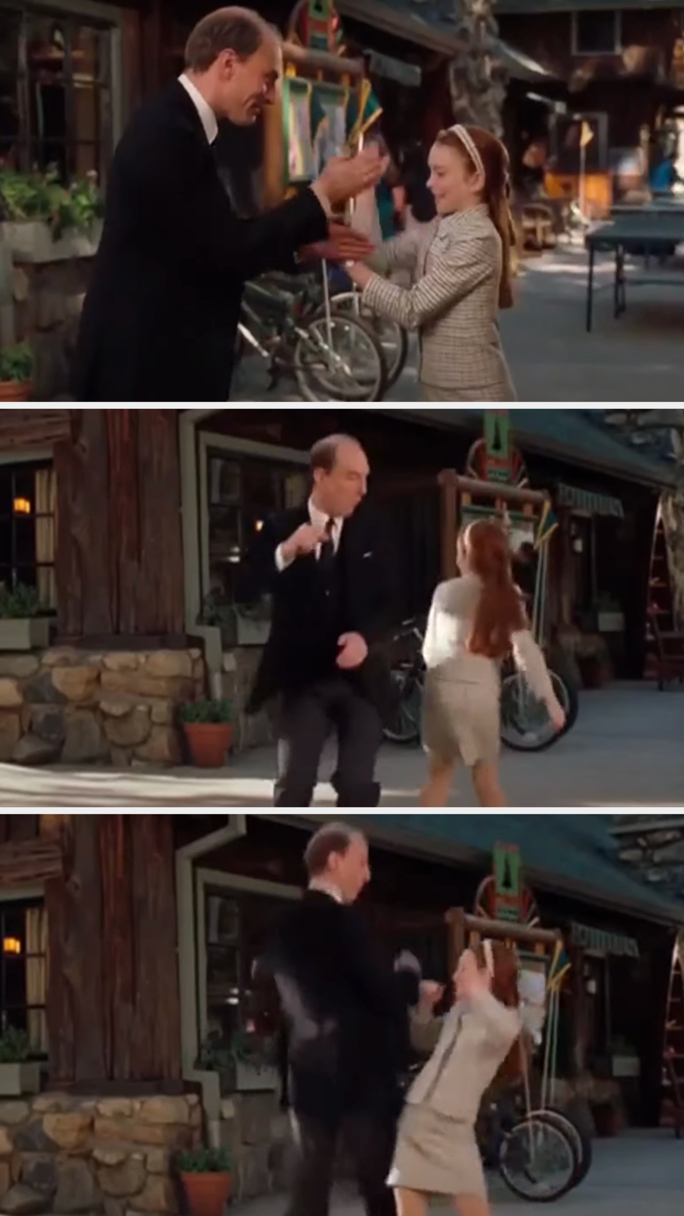 Simon and Lindsay doing a complicated handshake and bumping hips