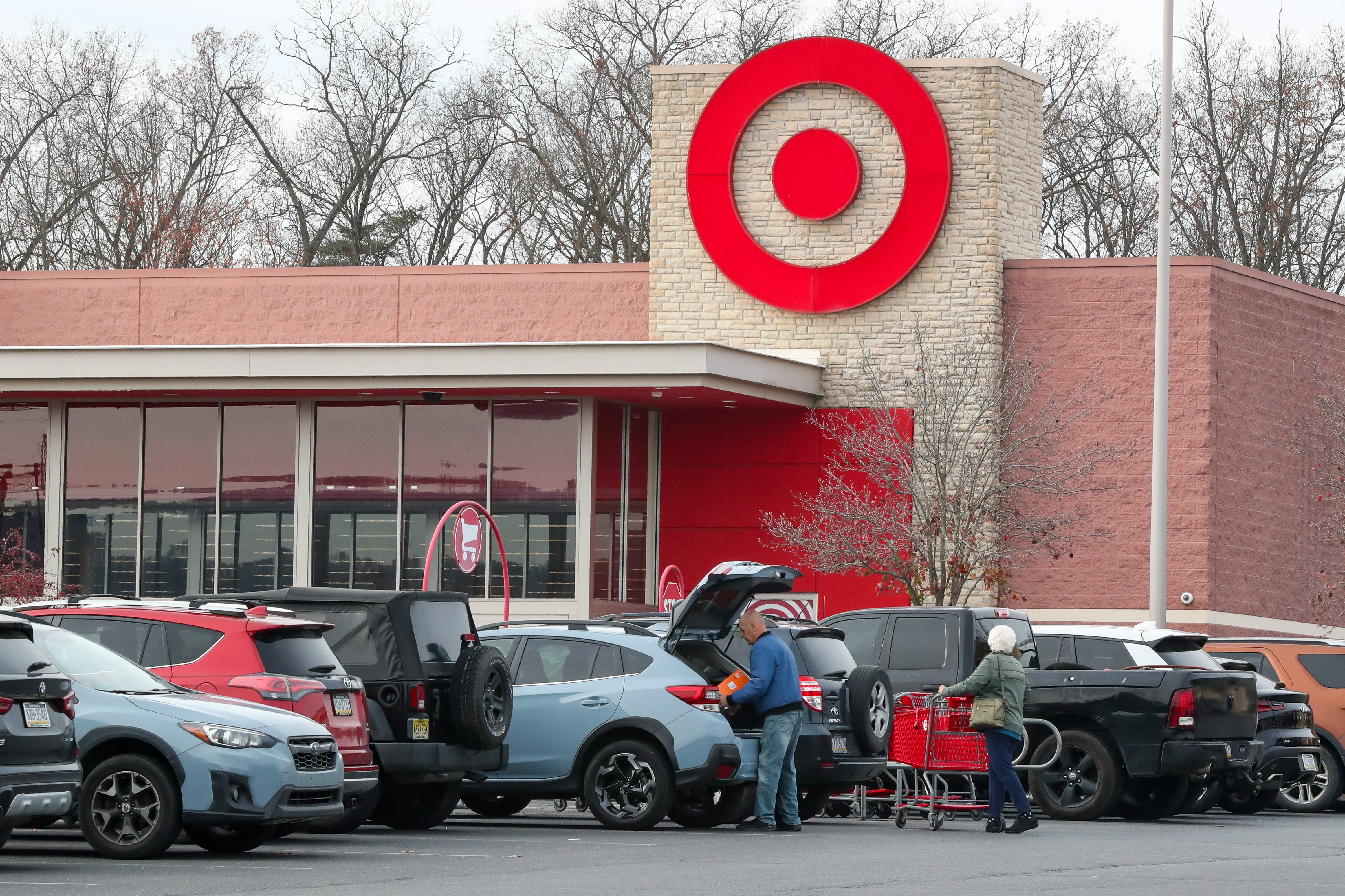 People loading a car in a busy Target parking lot