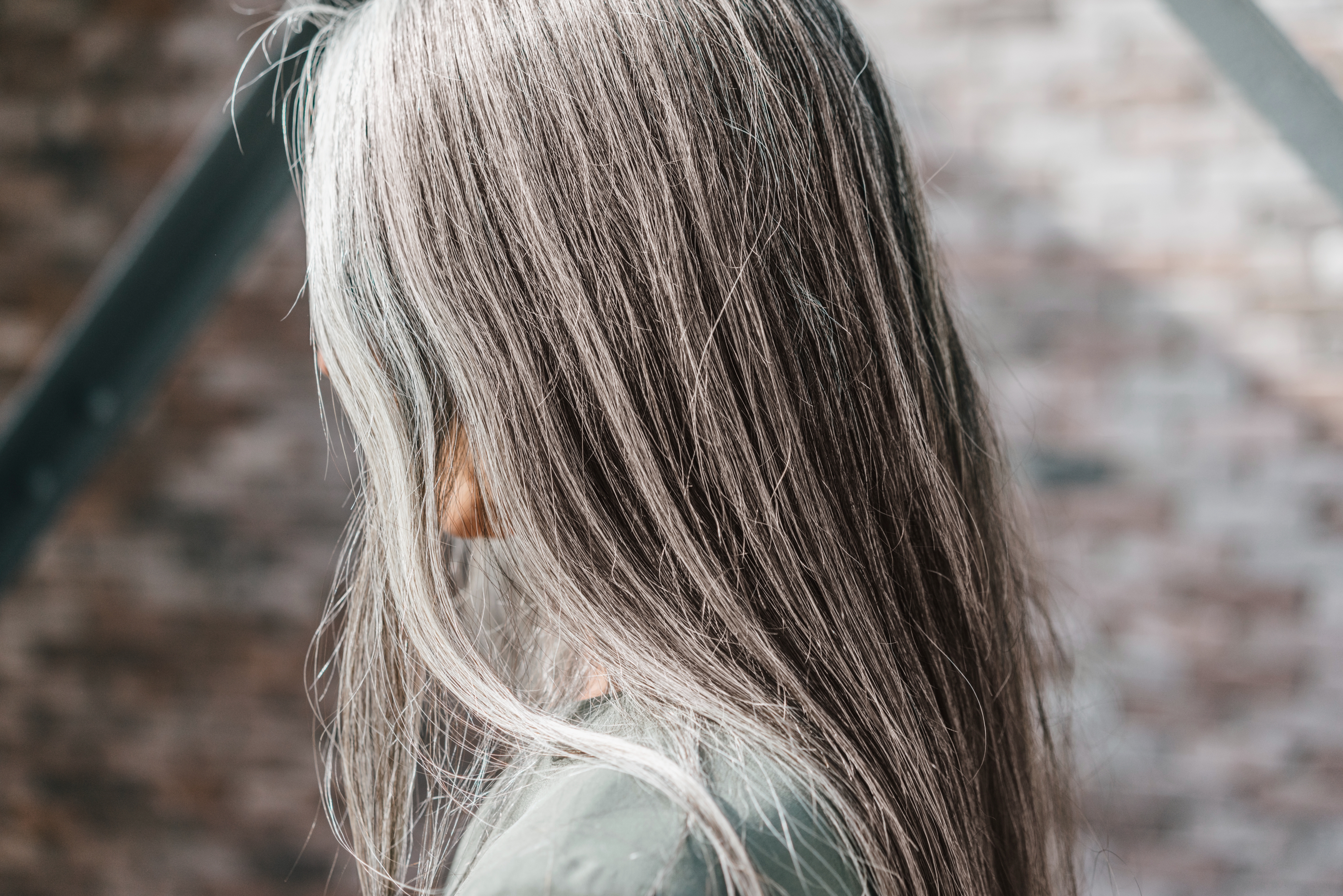 A person with long, straight gray hair.