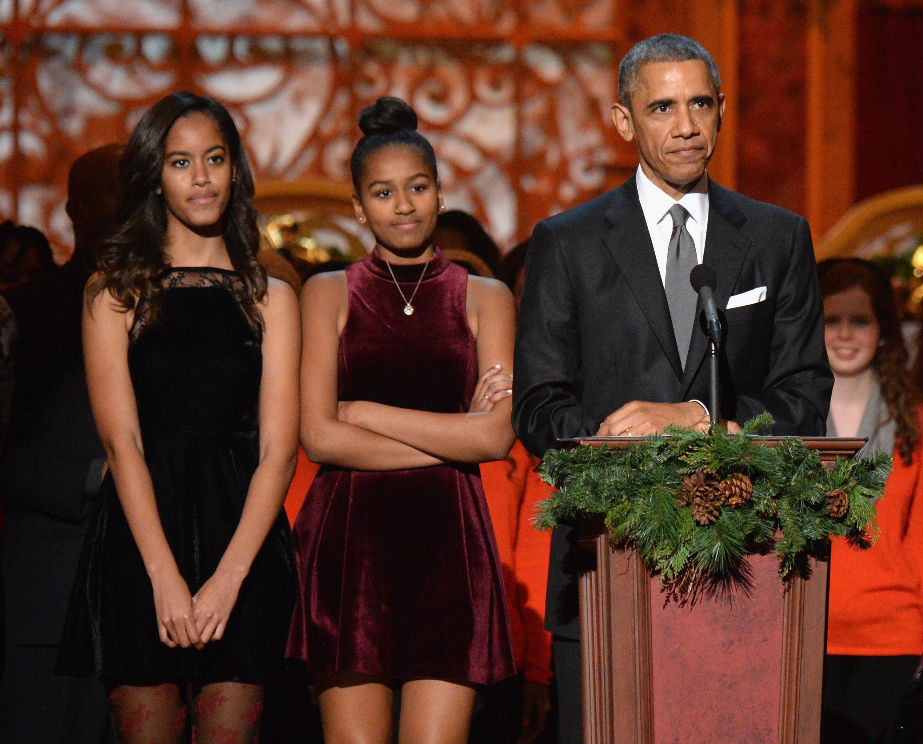 Malia Obama, Sasha Obama, and Barack Obama speak onstage at an event