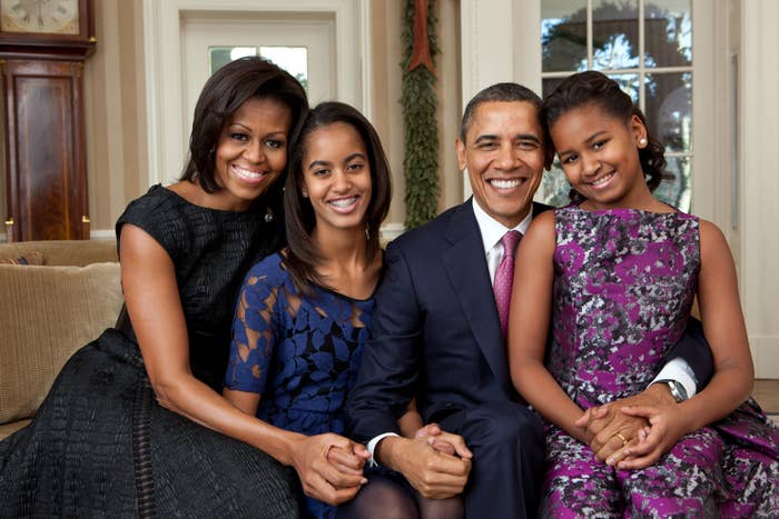 Michelle Obama, Malia Obama, Barack Obama and Sasha Obama sit for a family portrait in the Oval Office