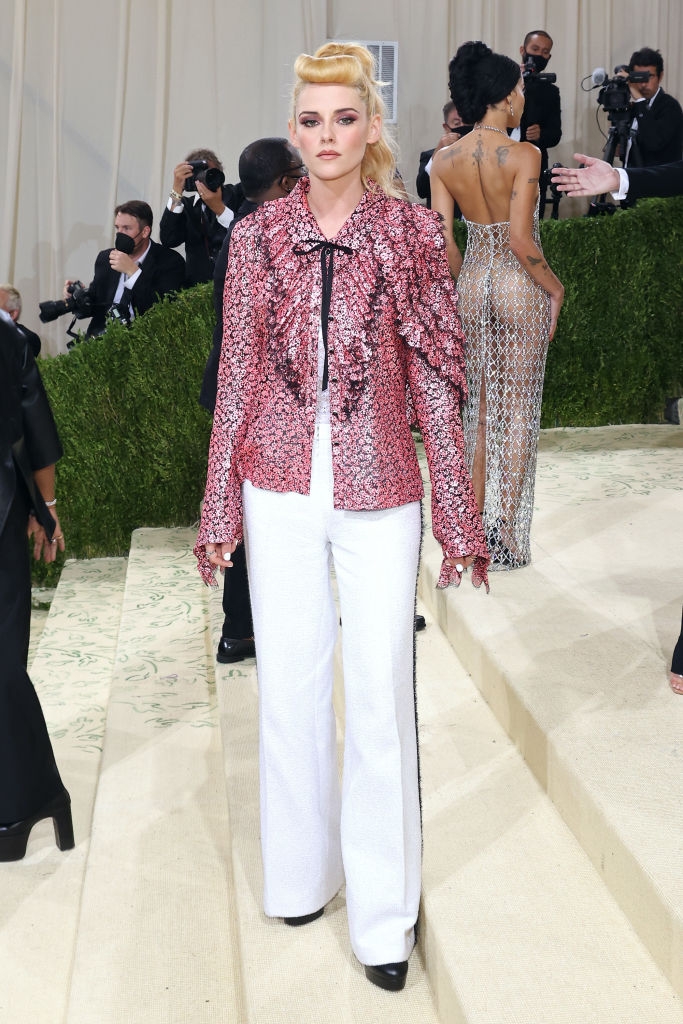 Kristen in a textured jacket with bow detail and wide-leg pants