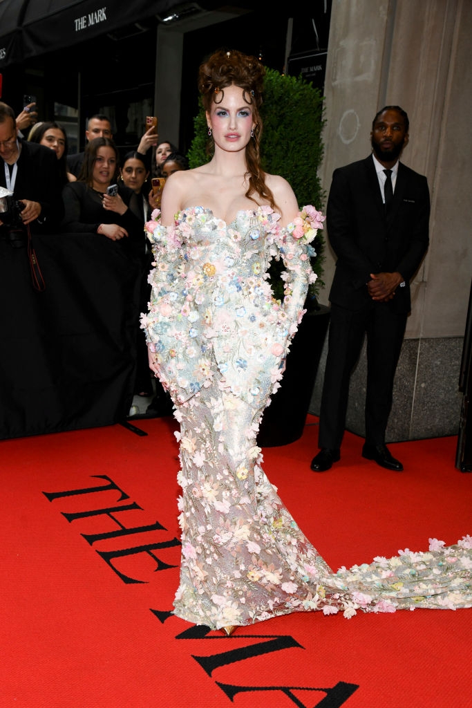 Haley in a sleeveless , shimmery gown decked in flowers with matching gloves