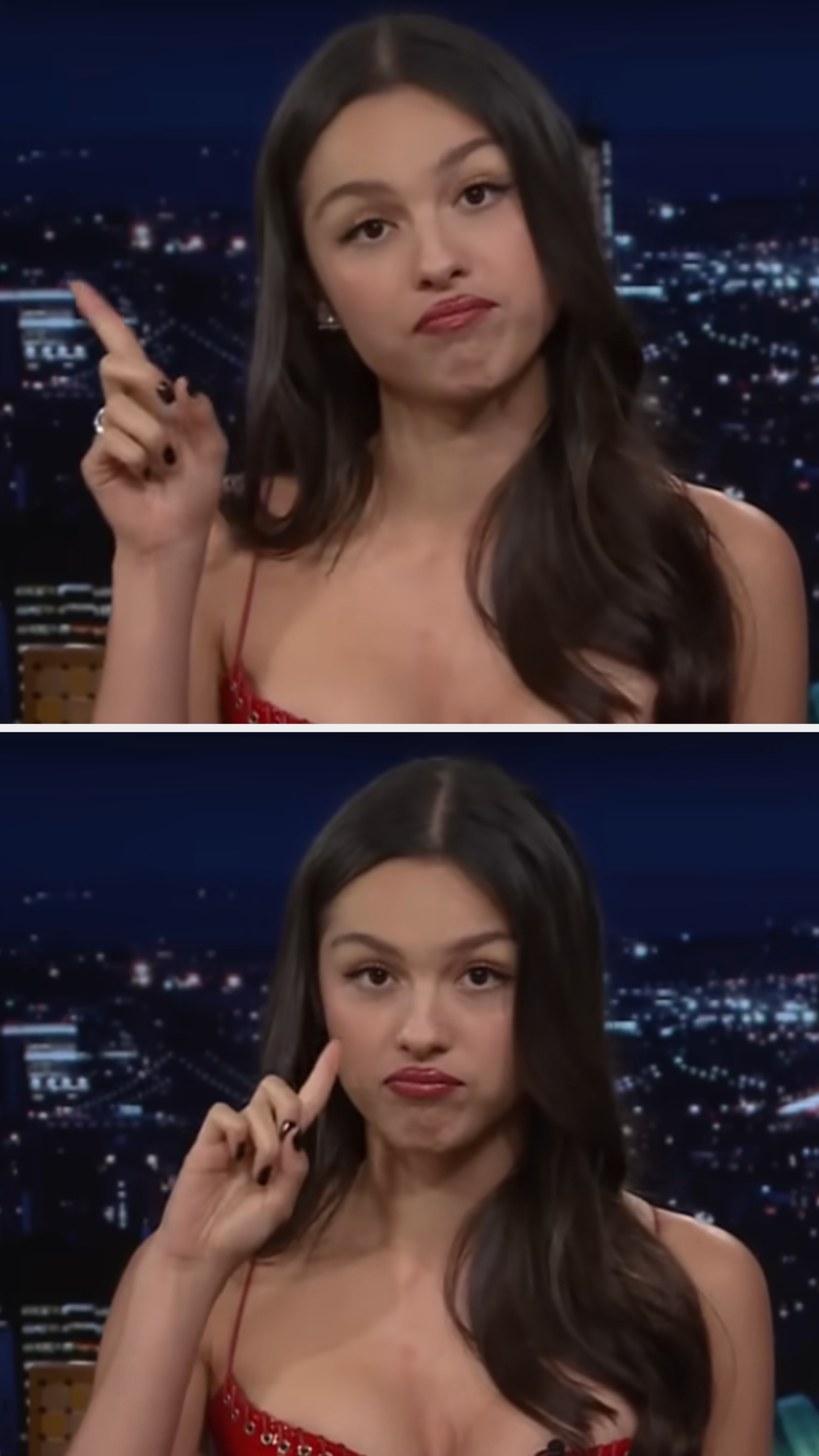 Person in a strapless outfit making playful, expressive gestures, with a nighttime cityscape in the background