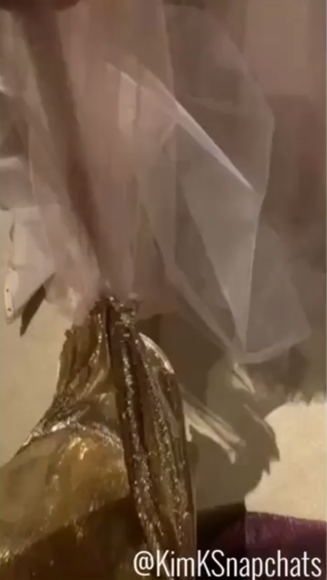the metallic skirt of Kim's dress caught on the delicate tulle of SZA's