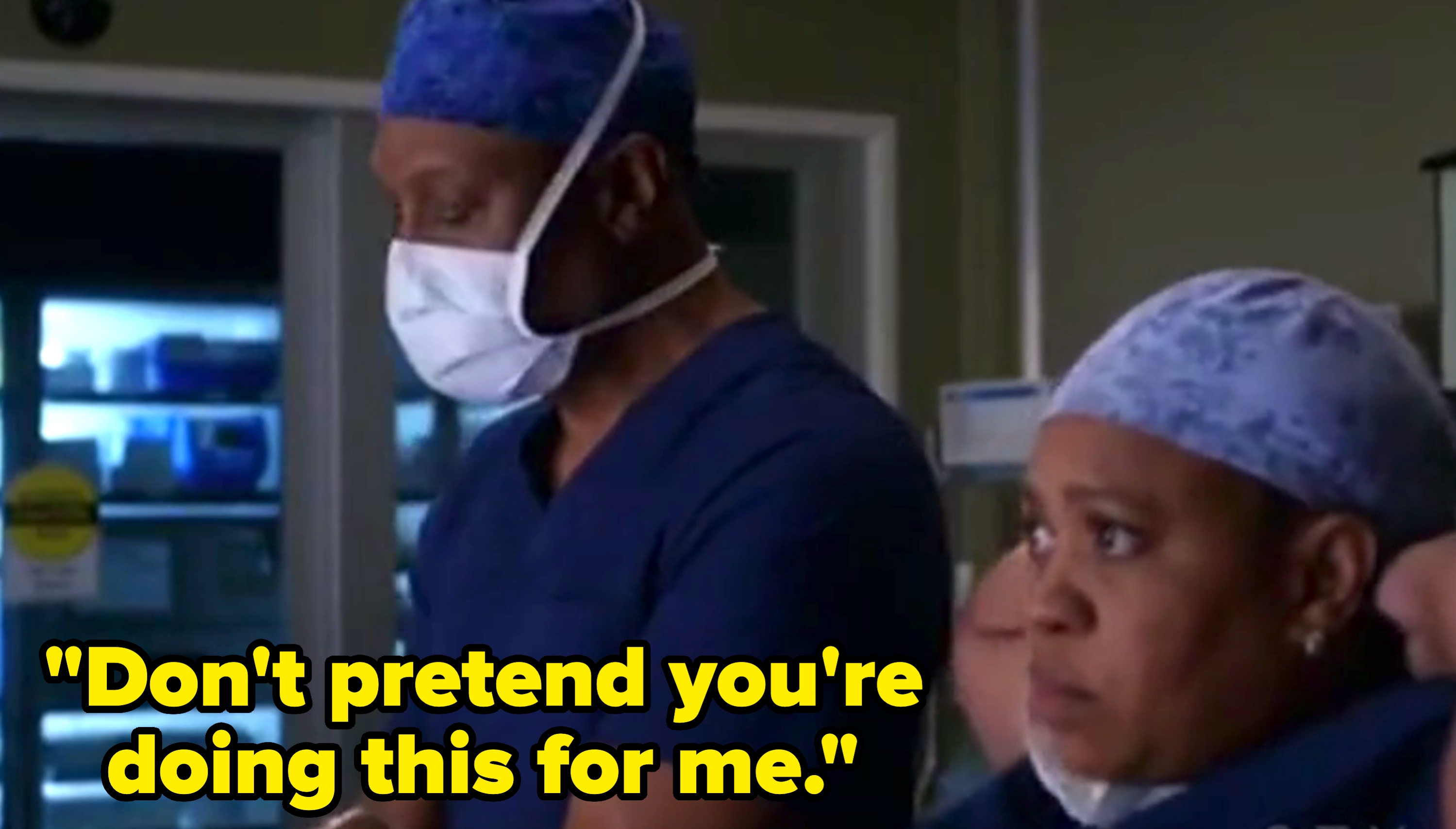 Two surgeons in scrubs and masks focus attentively, appearing to be in an operating room