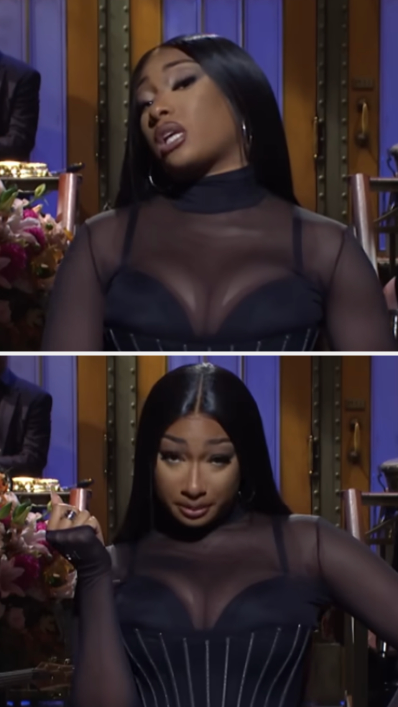 Person wearing a sheer top with corset detail on a stage, giving a playful expression, likely addressing an audience