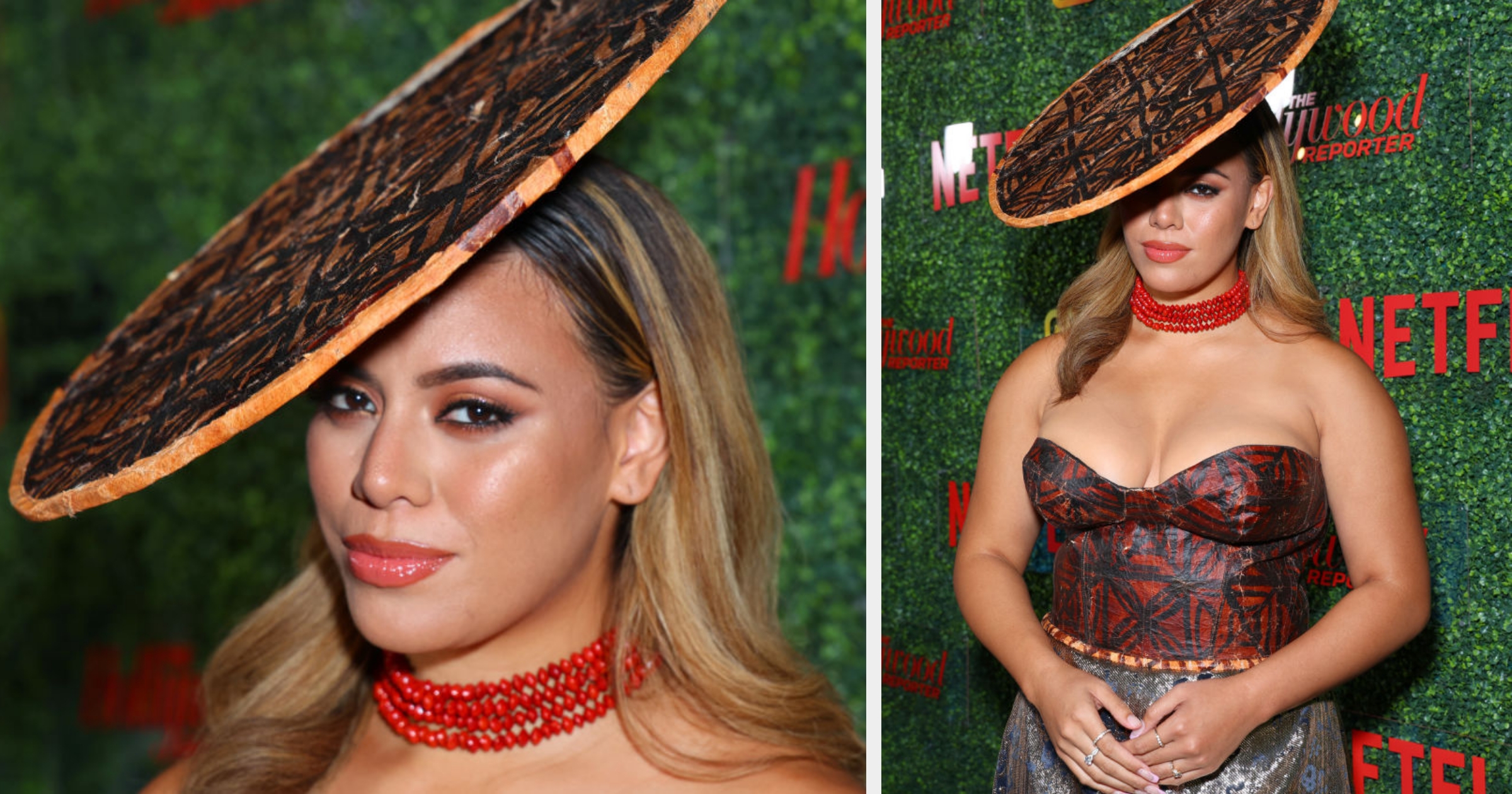 Person in strapless patterned dress, red beaded choker, and large disc hat poses on red carpet