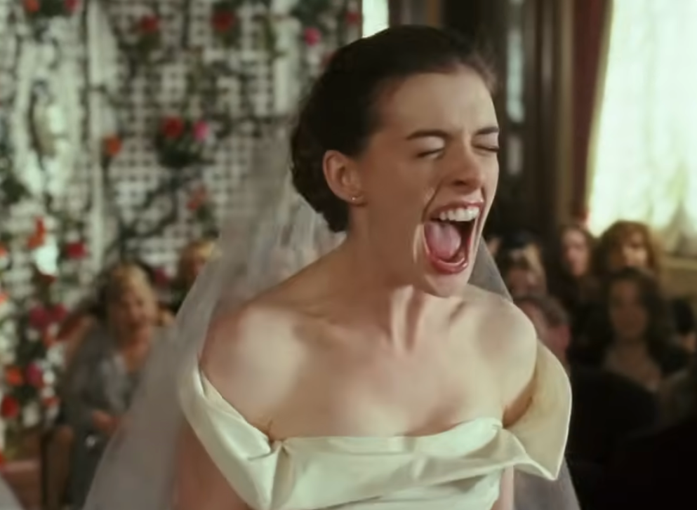 Bride in an off-the-shoulder dress screams during a wedding ceremony, surrounded by guests