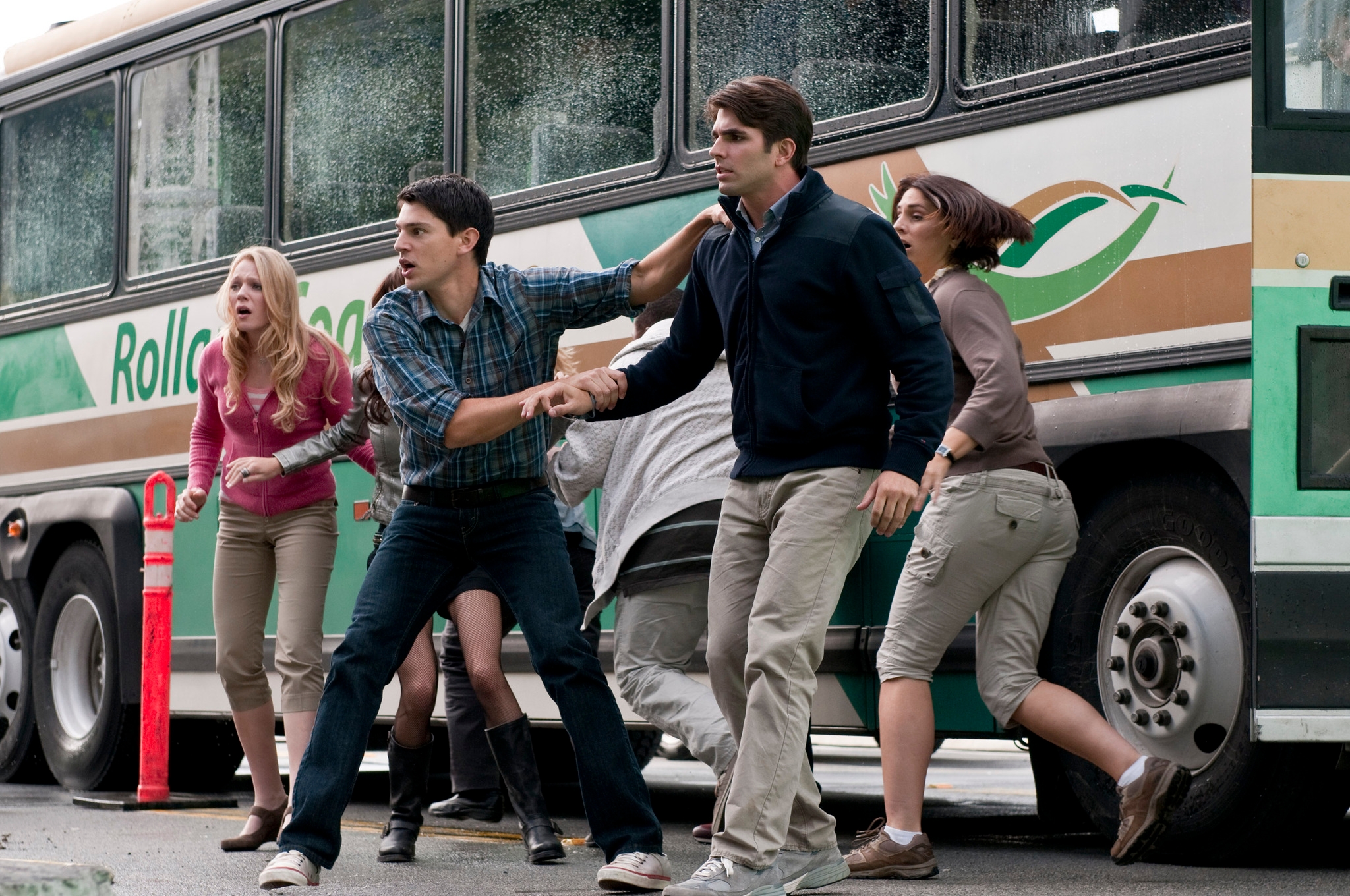 People in casual clothes urgently flee from a damaged bus, displaying fear and urgency