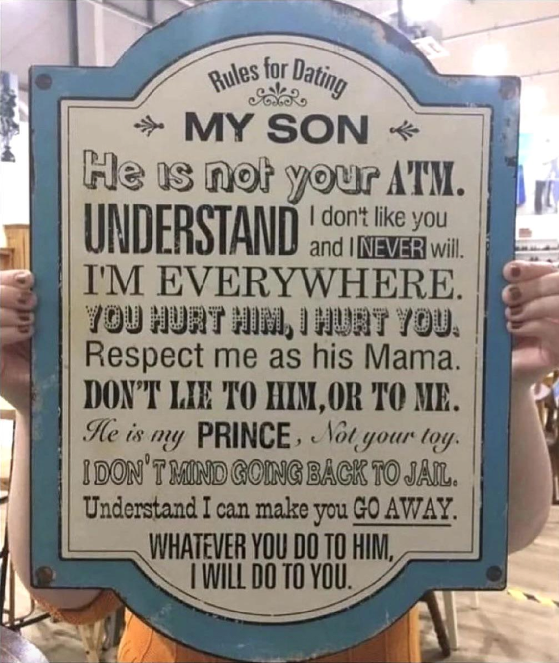 Sign with parenting advice humorously warning against mistreating the son, emphasizing respect and consequences for wrong actions