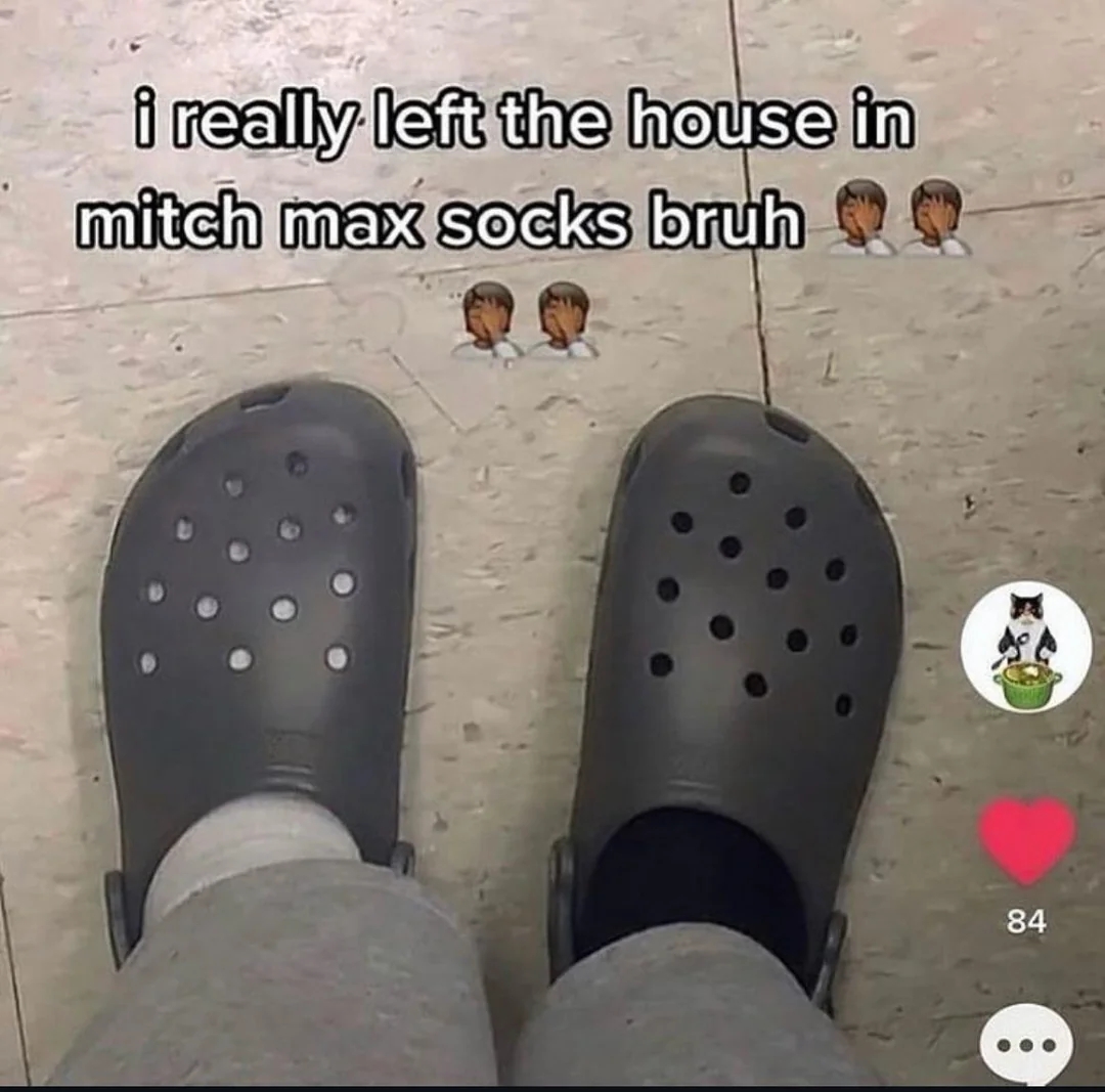 Person wearing mismatched socks with Crocs, captioned humorously about accidentally leaving the house like this