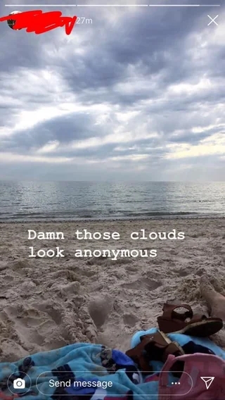 Beach scene with scattered clouds over the ocean. A towel and sandals lie on the sand. Text reads, "Damn those clouds look anonymous."