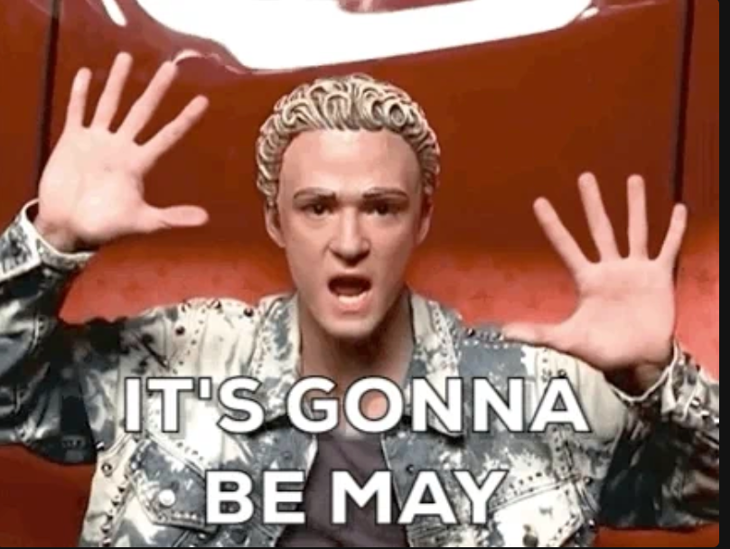 Man with curly hair and open-mouthed expression holds up both hands, captioned "IT'S GONNA BE MAY."