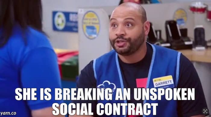 Man in store uniform humorously comments, "She is breaking an unspoken social contract," to a colleague. Background shows store elements