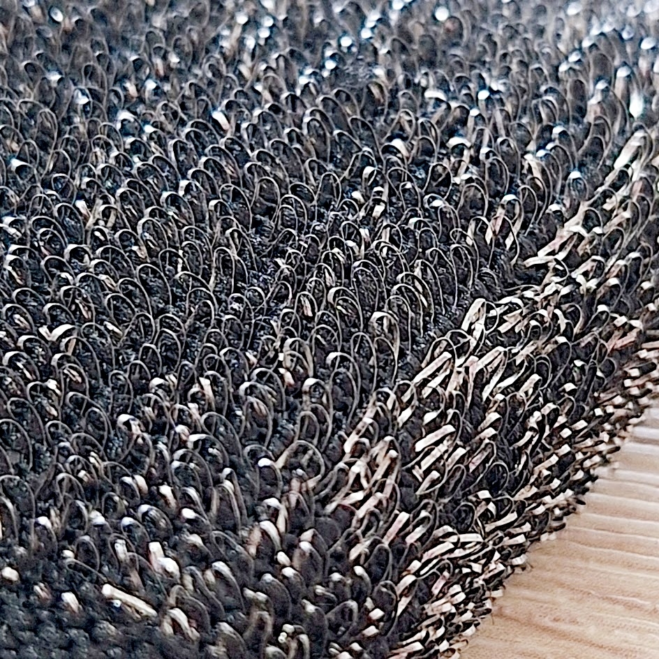 毛羽立った織物のクローズアップ。複雑なテクスチャーが目立ちます。