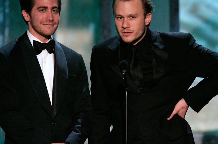 Jake Gyllenhaal and Heath Ledger in tuxedos on stage