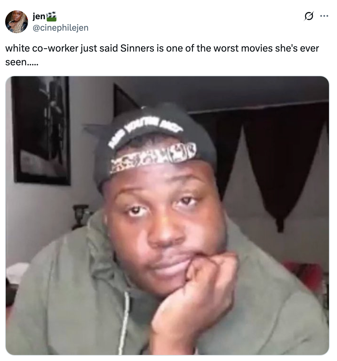 A person in a hoodie and cap looking unimpressed, captured in a meme about a coworker's opinion on the movie "Sinners."