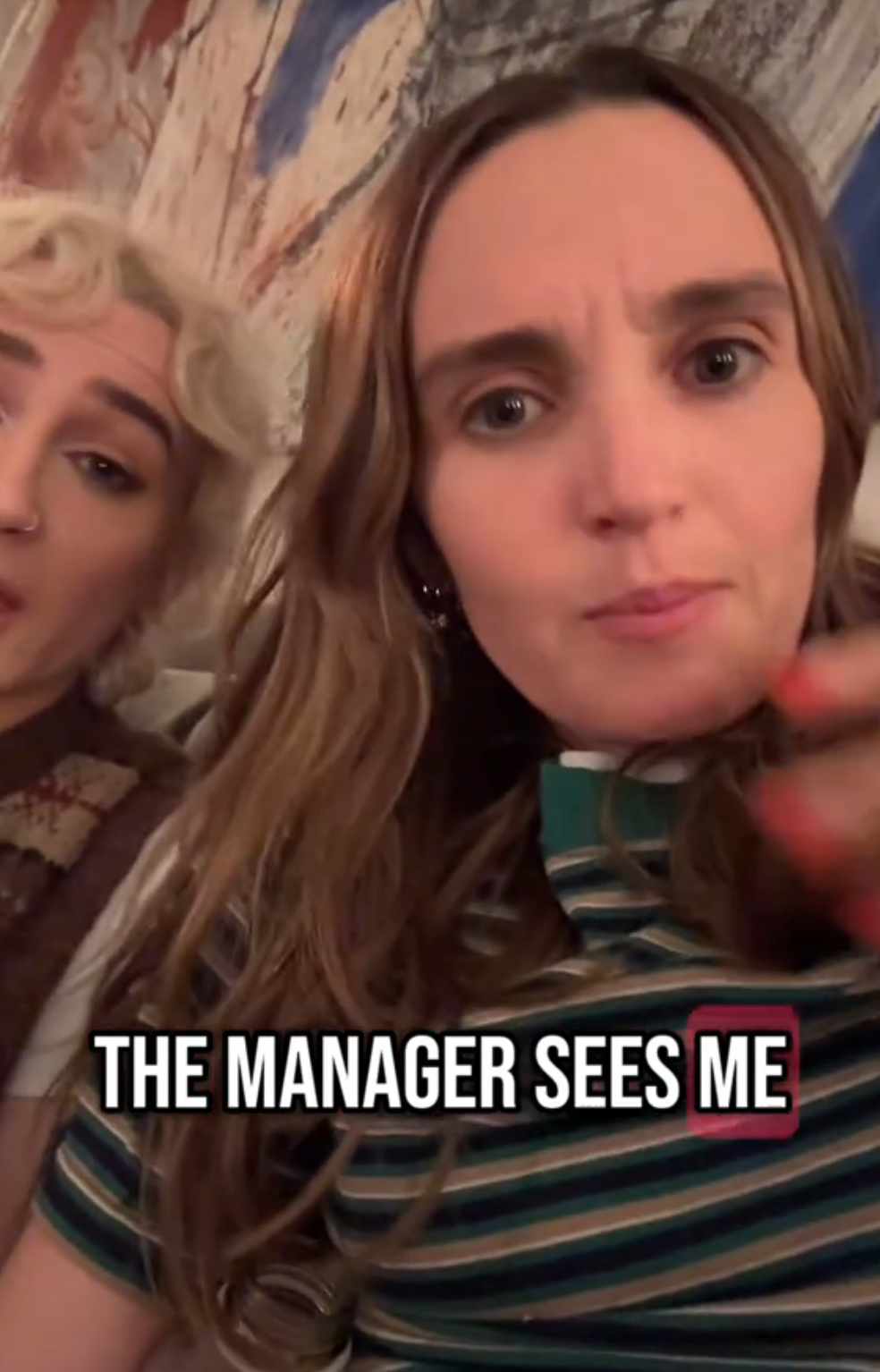 Two people sitting, one in a striped shirt. Text reads: "THE MANAGER SEES ME."