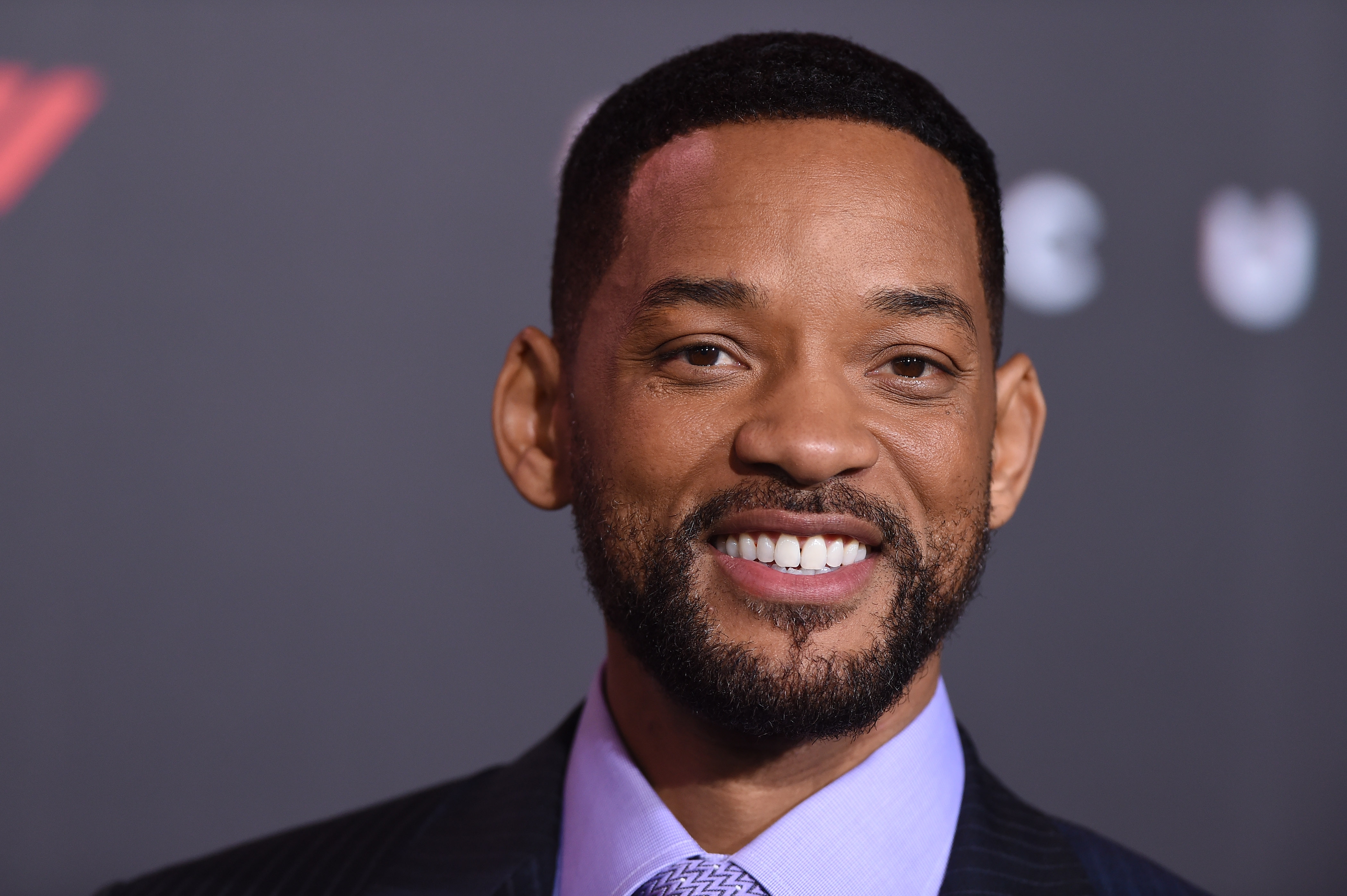 Will Smith at a formal event, wearing a suit and tie