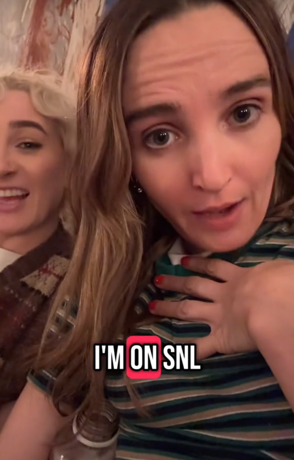 Two people are smiling, one points to themselves with text overlay: "I'm on SNL."