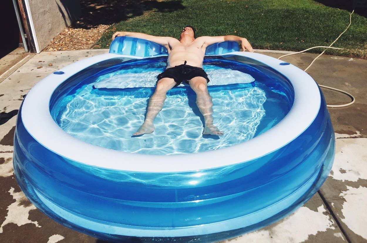 reviewer relaxing on the pool's built-in seat