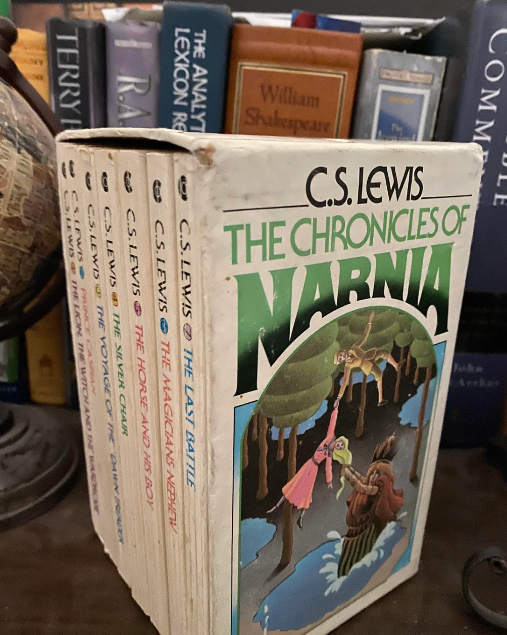 Box set of "The Chronicles of Narnia" by C.S. Lewis, with seven books, displayed on a bookshelf