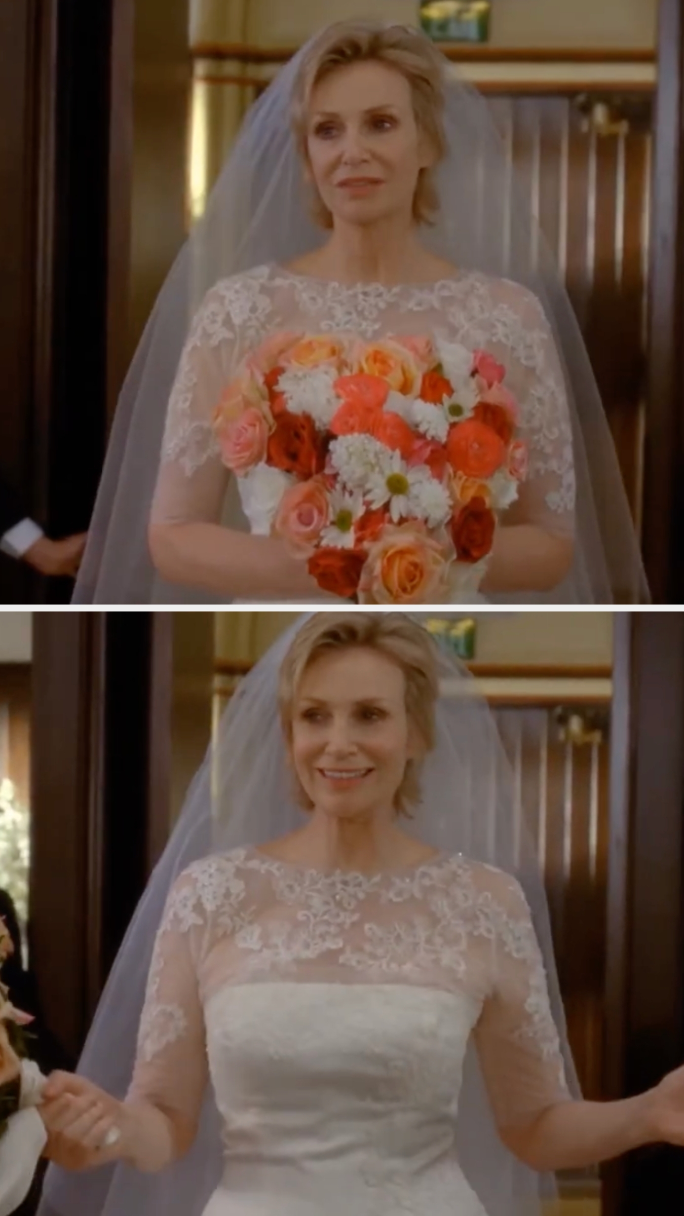 A person in a lace wedding dress holds a bouquet of mixed flowers, walking down the aisle with a joyful expression