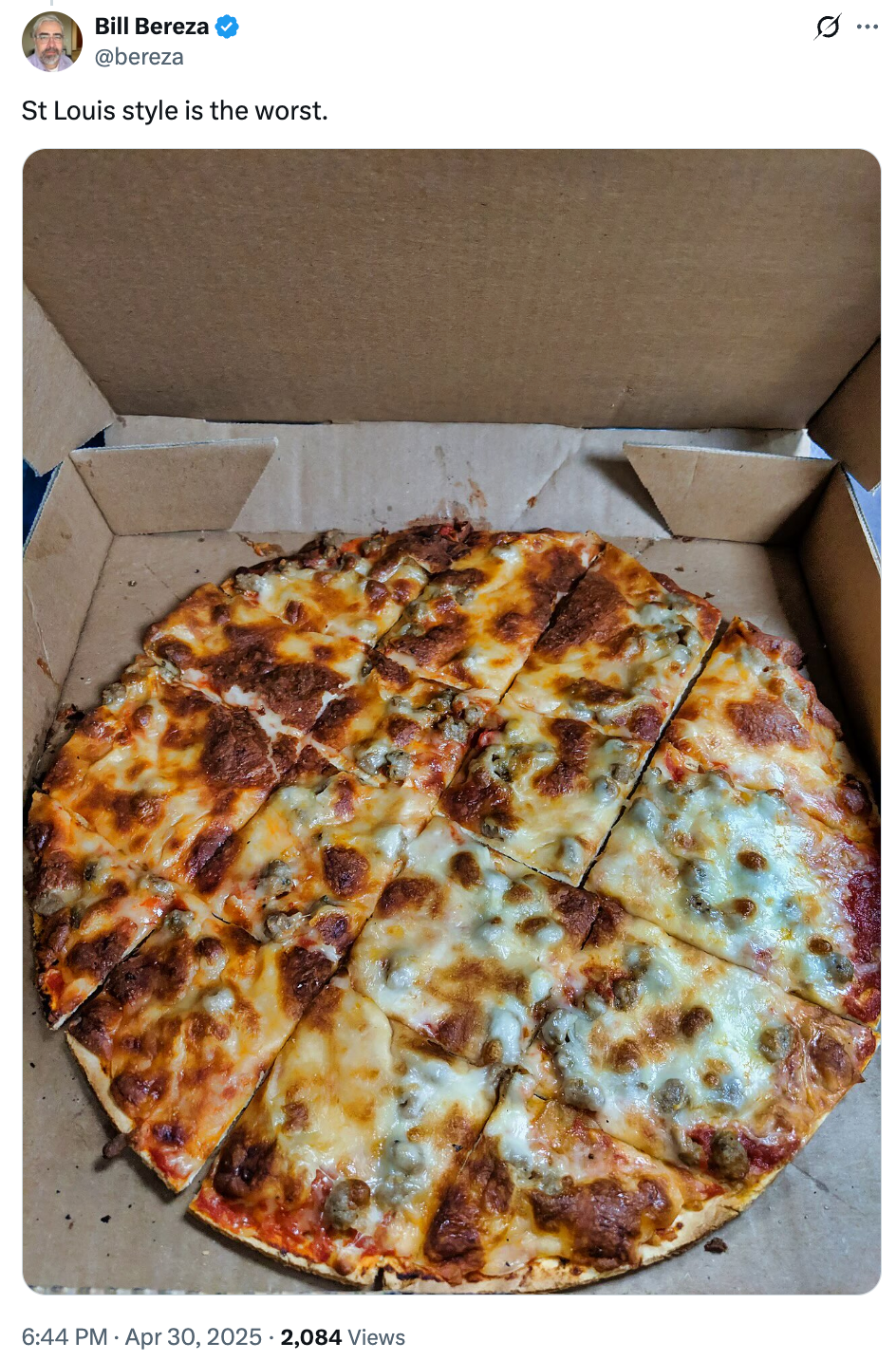 Thin-crust pizza cut into square slices in a box, labeled with a negative opinion on St. Louis-style pizza