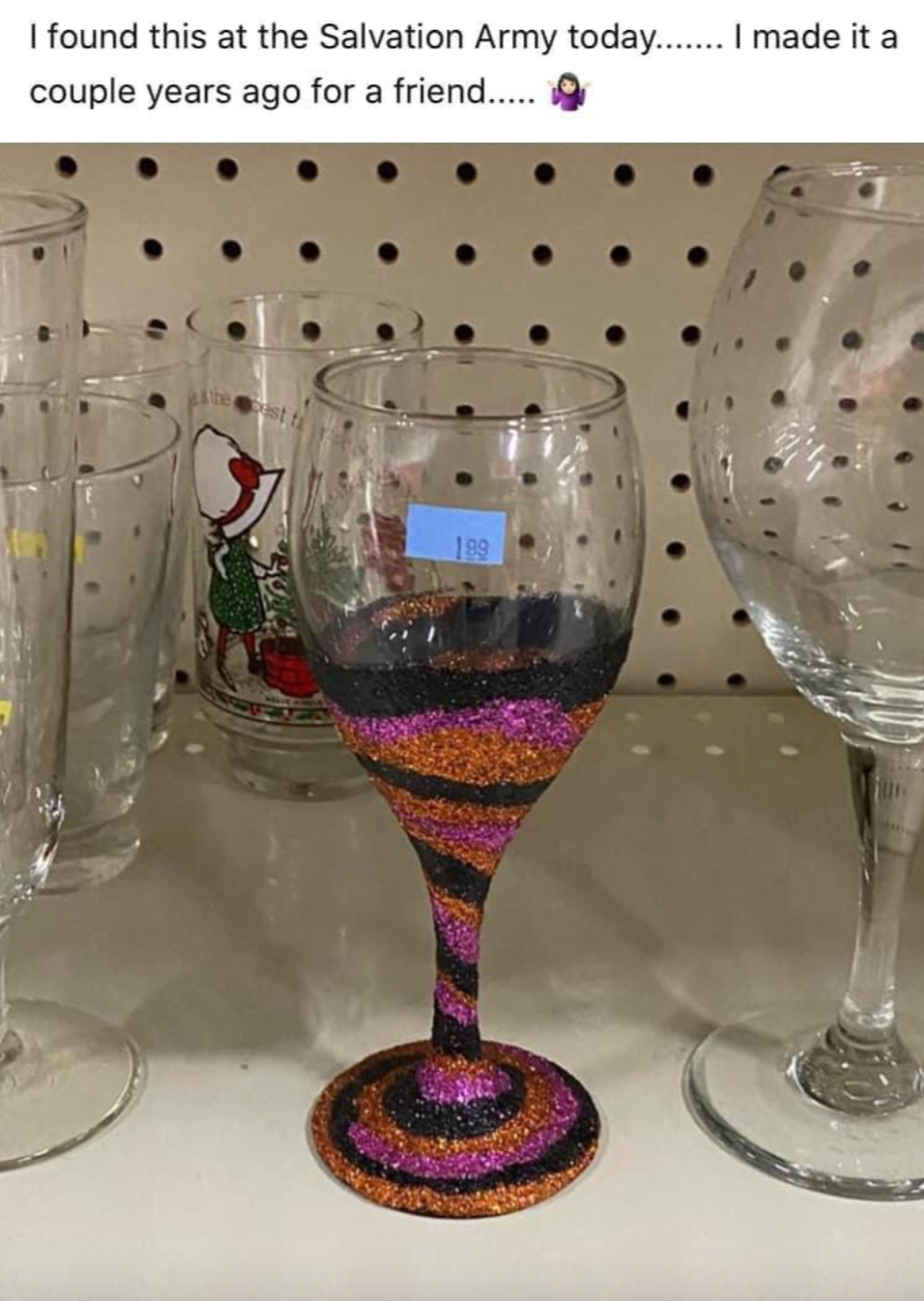 A glittery striped wine glass spotted at Salvation Army with a humorous text about its creation for a friend