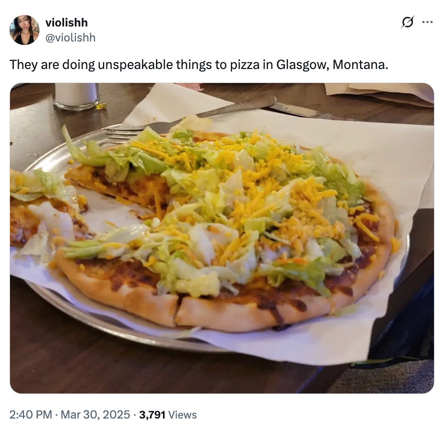 Pizza topped with shredded lettuce and cheese on a plate; person expressing surprise about the unconventional toppings