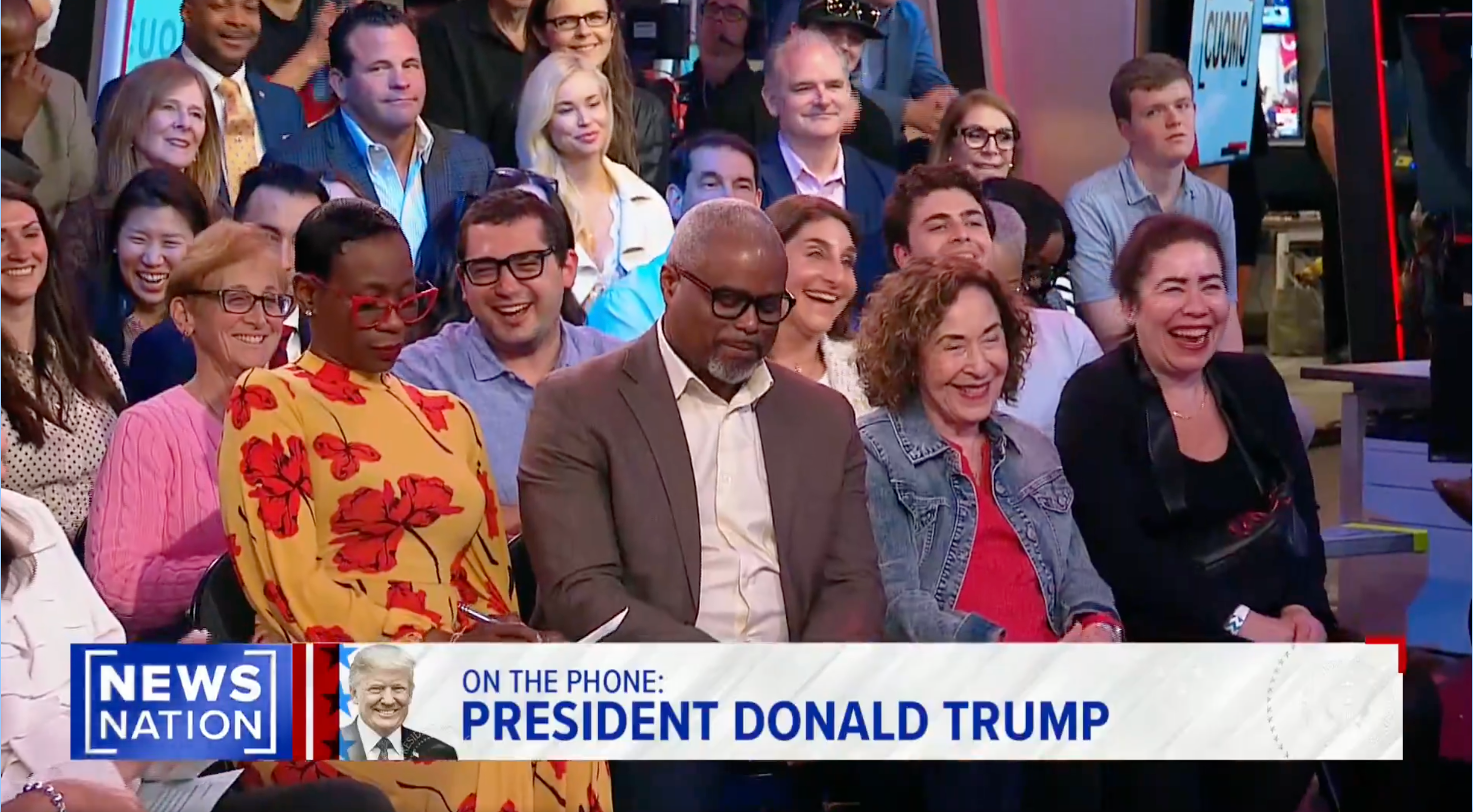 Audience laughing during a TV show segment with a phone interview captioned "ON THE PHONE: PRESIDENT DONALD TRUMP," aired by News Nation