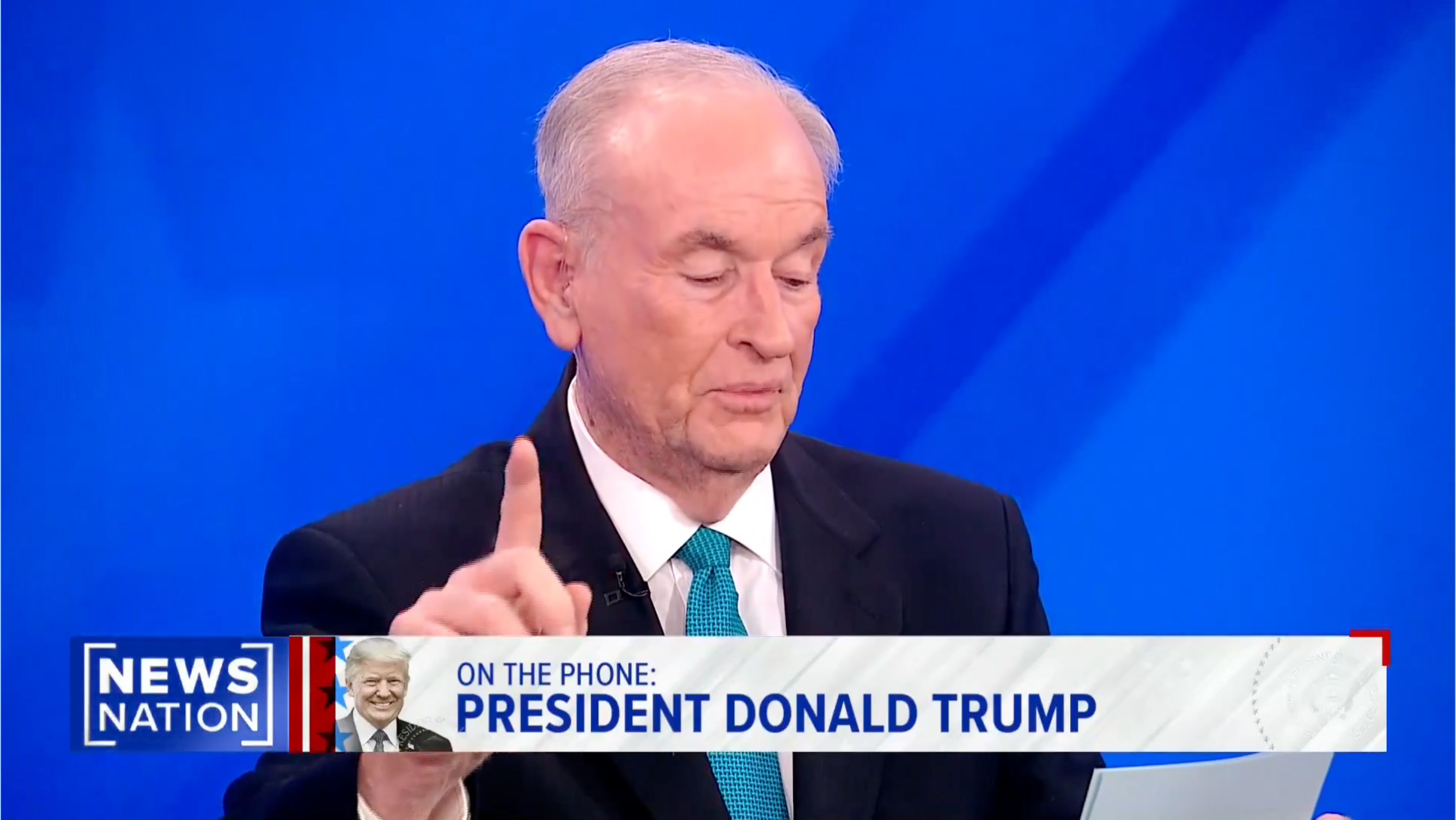 Bill O'Reilly is speaking on a TV news program, holding up a finger. The text on the screen mentions "President Donald Trump."