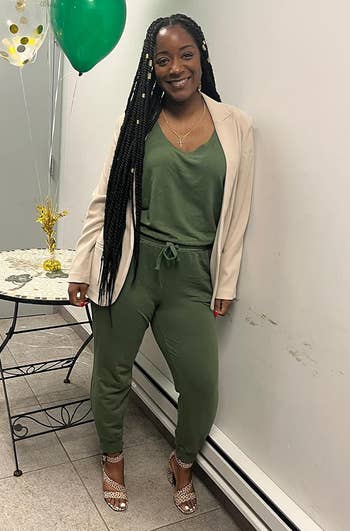 Reviewer wearing the subject greenish jumpsuit
