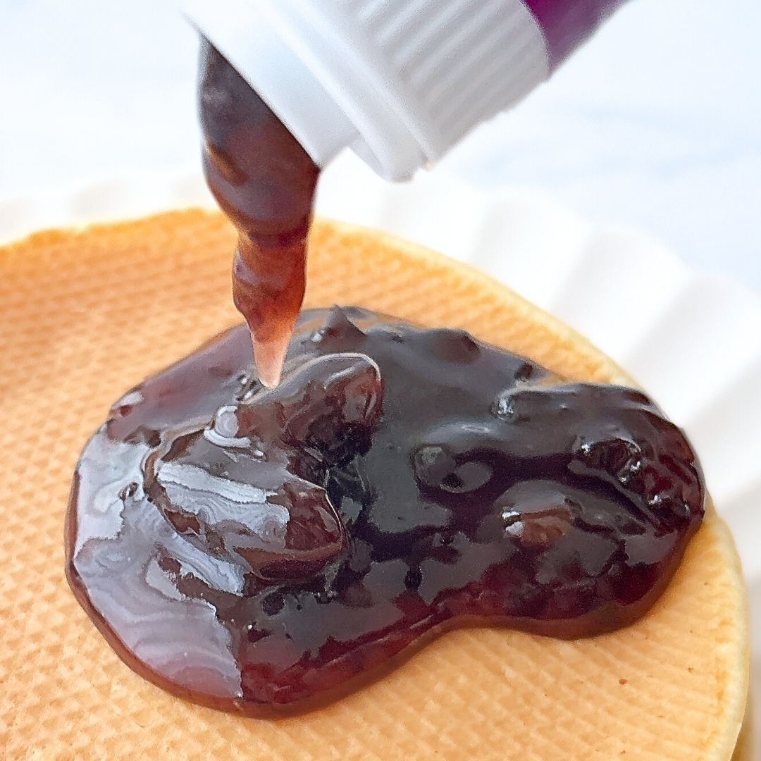 ワッフルの上にチョコレートソースが注がれている様子。