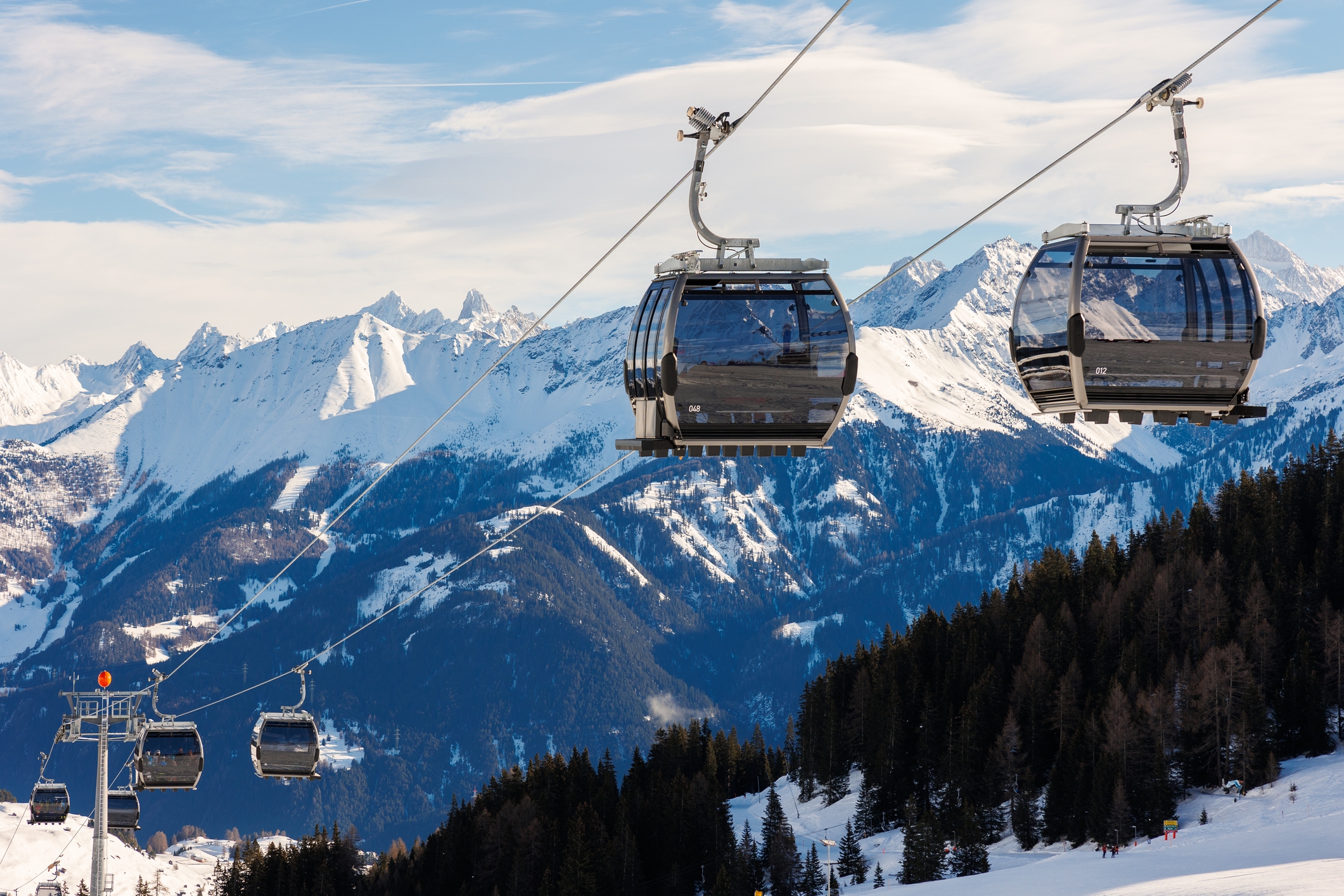 Ski resort gondolas traverse snowy mountains, offering scenic views