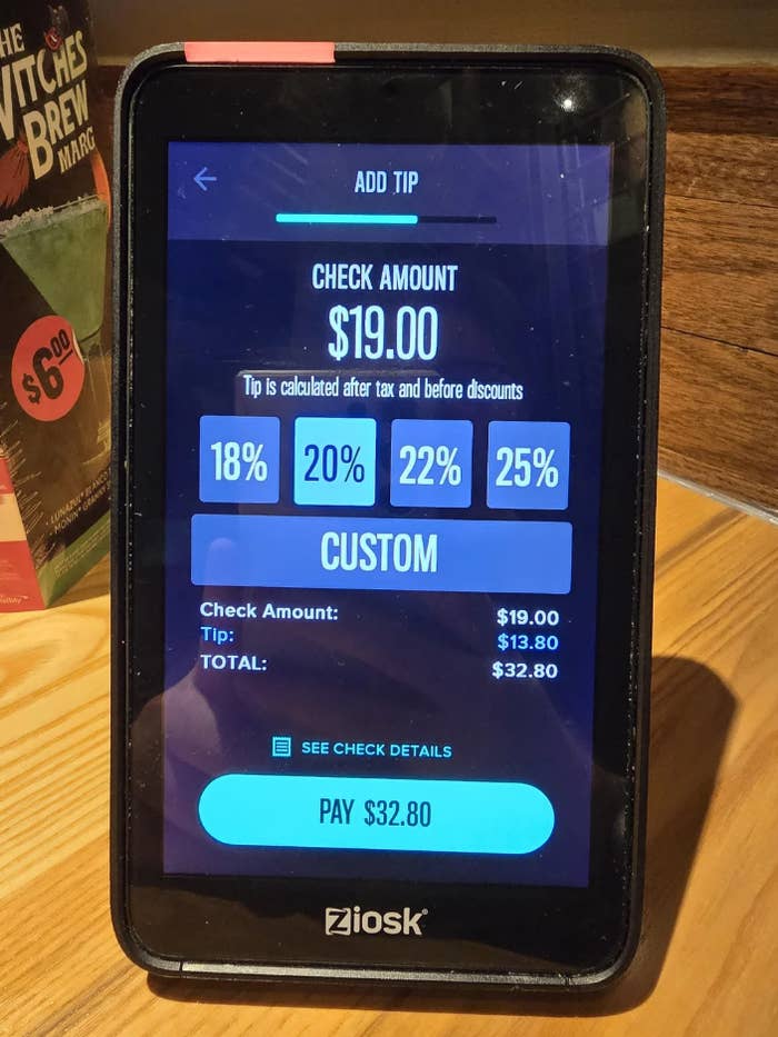 Tablet screen displaying a payment interface with options to add a tip of 18%, 20%, 22%, or 25% to a $19 check amount, totaling $32.80