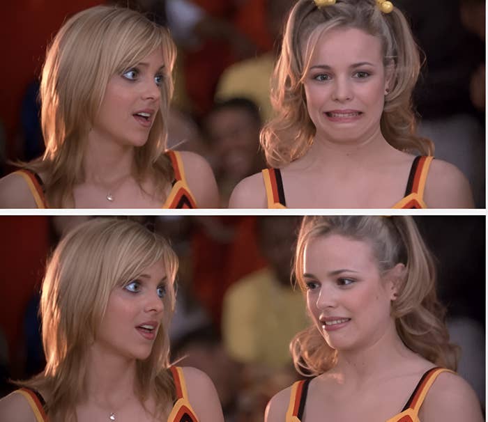 Two women in cheerleader uniforms; one appears surprised while the other has a nervous expression