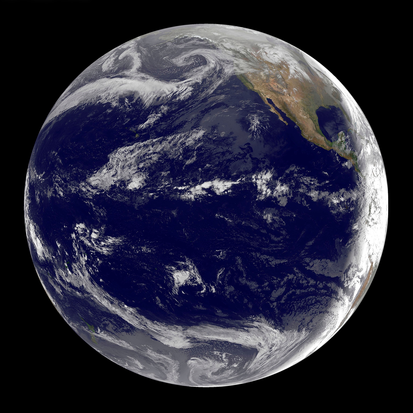 View of Earth from space, showing swirling cloud patterns over the Pacific Ocean and parts of North and South America, but mostly water