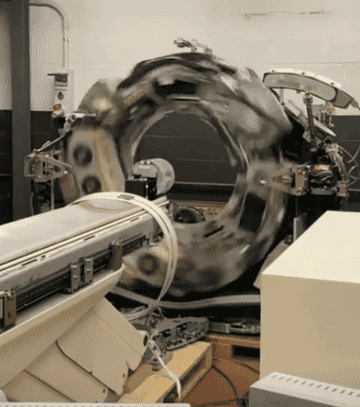 A mechanical machine rotates rapidly in a workshop, showcasing industrial motion and technology in action